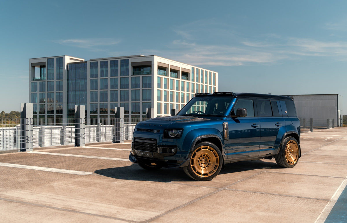 Blue Urban Defender 110 with bronze wheels